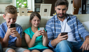 Family using phone in living room