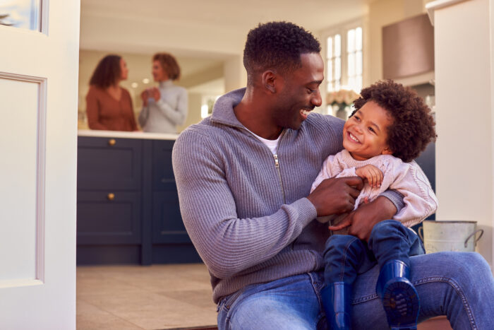 young homeowner and father with son laughing at home