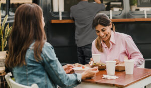 two women enjoying lunch at outdoor cafe