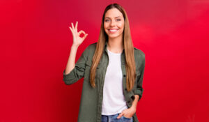 young woman showing approval with "okay" hand signal