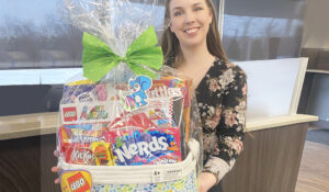 Staff member, Amilia, displays Easter basket prize