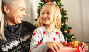 child and grandmother with holiday gift