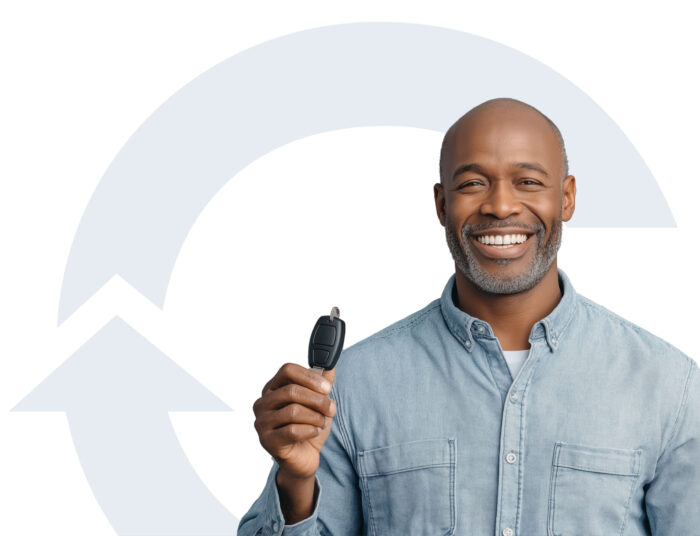 smiling man with key to new car
