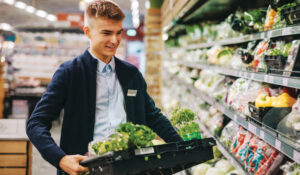 Teen boy working at grocery, stock-boy